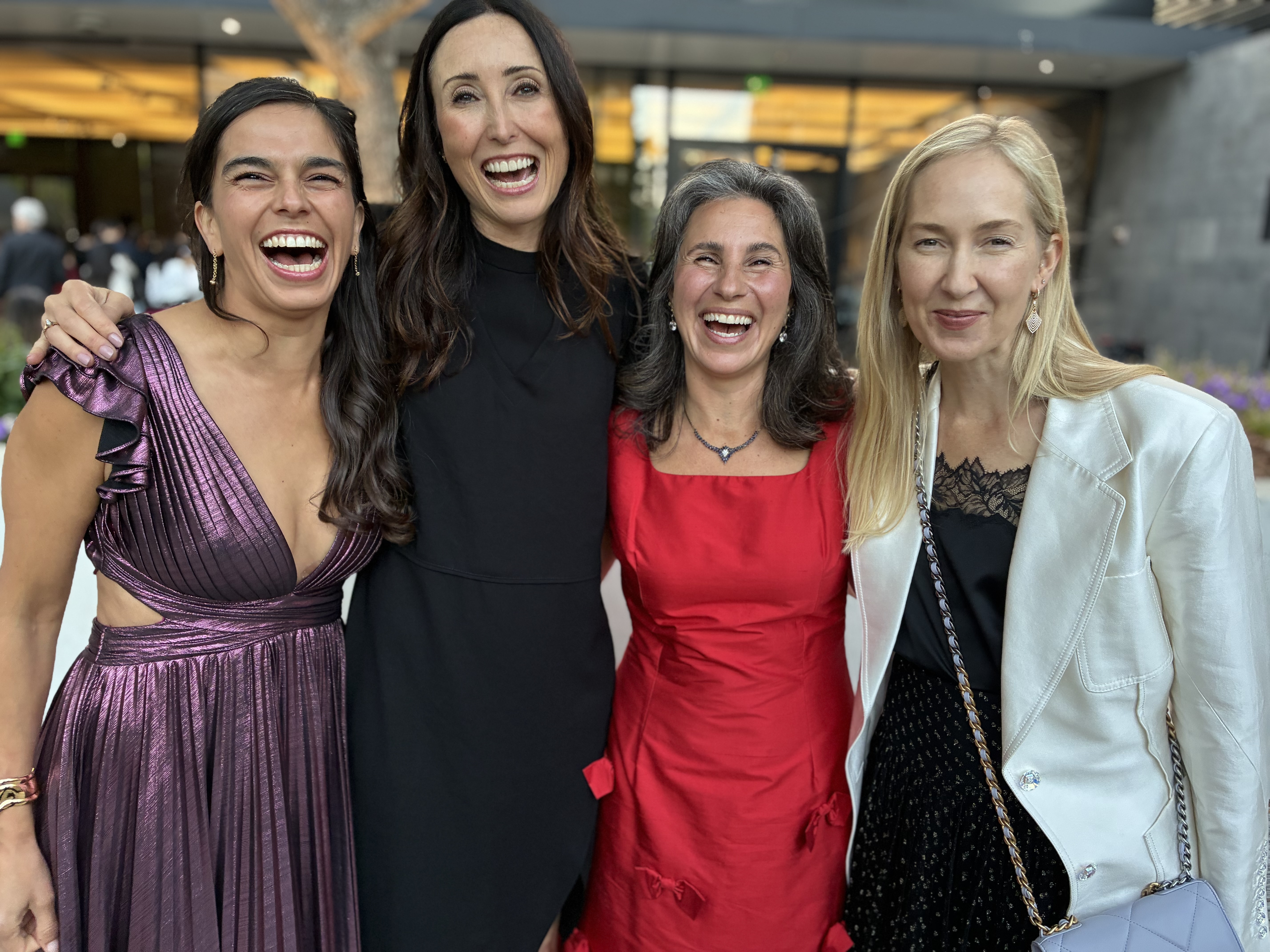 Cris with friends dressed up at an evening event
